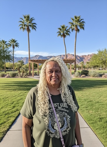 Iris J Hill-Baker. Founder of Wealth Health Beauty Shop. Iris J Hill-Baker. Founder of Wealth Health Beauty Shop standing at a park in Las Vegas with a dark colored t-shirt on